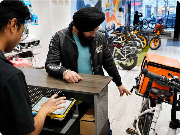Customer consulting with salesperson at Movin electric bike store in Toronto