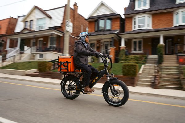 Food courier riding Movin Pulse electric bike for fast urban delivery service