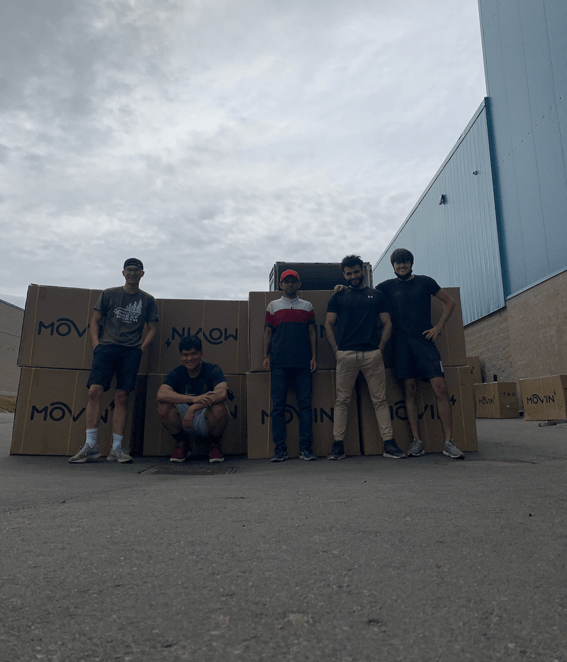 Workers at Movin facility readying electric bicycle order for outbound shipping