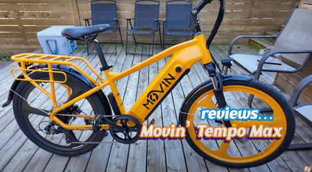 Movin Tempo Max e-bike in orange color resting on porch, ready for urban commuting