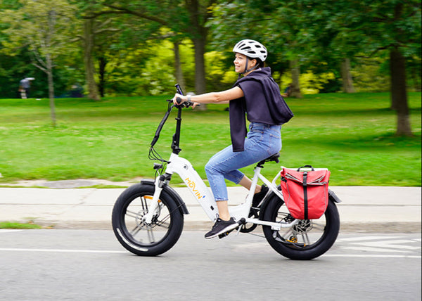 Person riding a movin electric bike with a pannier in a park