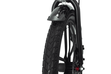 Front wheel of Movin electric bicycle highlighting deep tread for road and trail traction